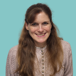 Image of a woman smiling, with long hair that is over her shoulders