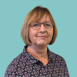 Image of a woman with blonde chin length hair, wearing glasses, smiling